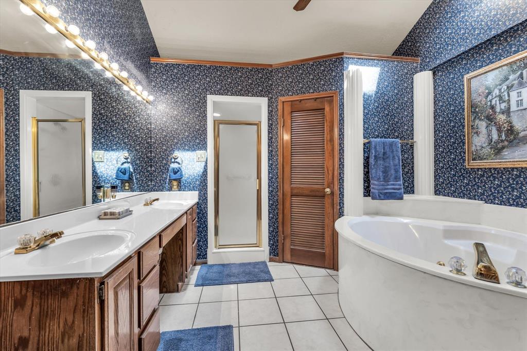 1438 Bend Of The Bosque Road China Spring, TX 76633 - Photo 13 of 33 Double vanity with built-in cabinetry, large mirror, and overhead lighting