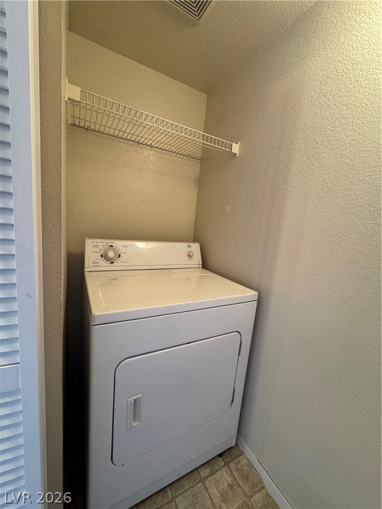 7255 West Sunset Road, Unit 2081 Las Vegas, NV 89113 - Photo 12 of 20 Laundry area with washer / dryer and a textured wall