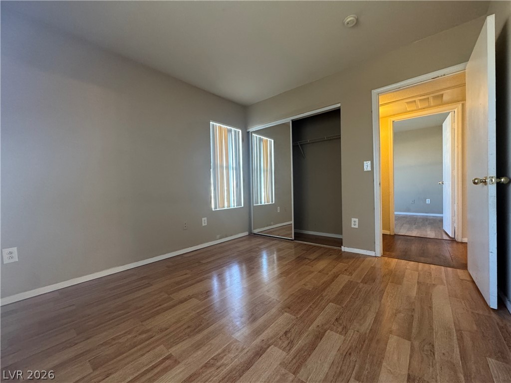 7255 West Sunset Road, Unit 2081 Las Vegas, NV 89113 - Photo 16 of 20 Unfurnished bedroom featuring wood finished floors and a closet