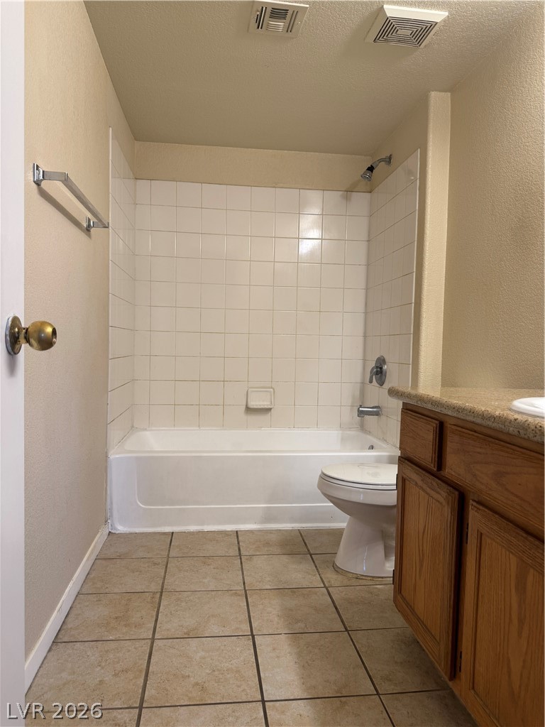 7255 West Sunset Road, Unit 2081 Las Vegas, NV 89113 - Photo 20 of 20 Full bath featuring a textured wall, vanity, tub / shower combination, a textured ceiling, and light tile patterned floors