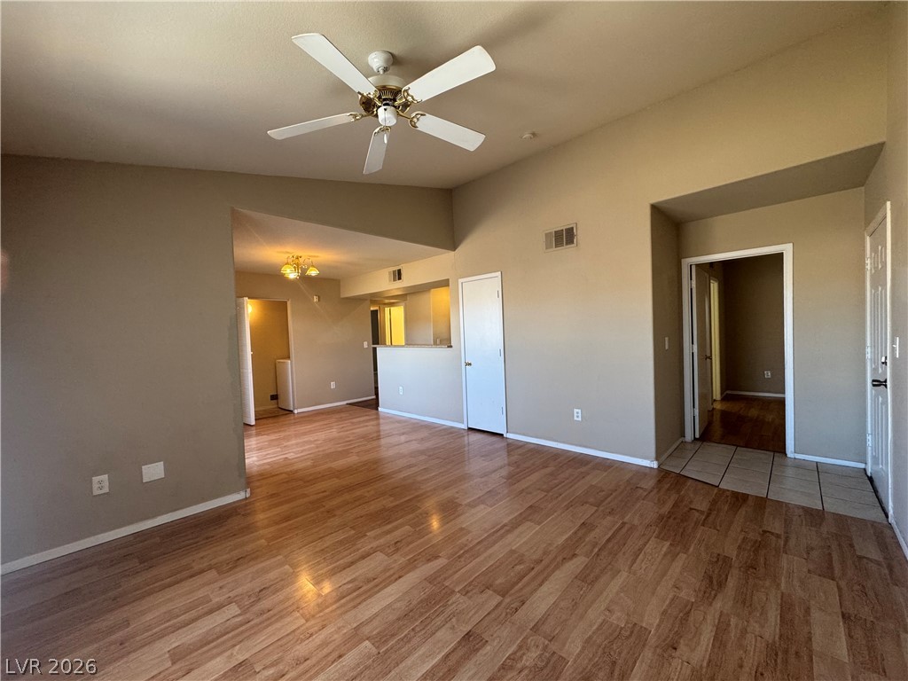 7255 West Sunset Road, Unit 2081 Las Vegas, NV 89113 - Photo 3 of 20 Unfurnished living room featuring lofted ceiling, light wood-style flooring, and ceiling fan