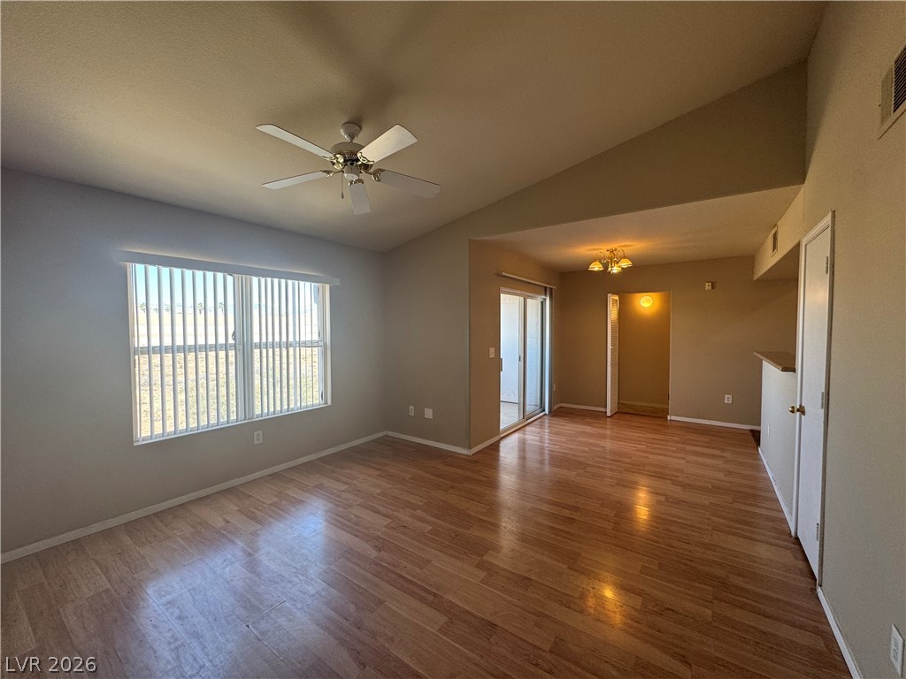 7255 West Sunset Road, Unit 2081 Las Vegas, NV 89113 - Photo 4 of 20 Empty room with lofted ceiling, a ceiling fan, and wood finished floors