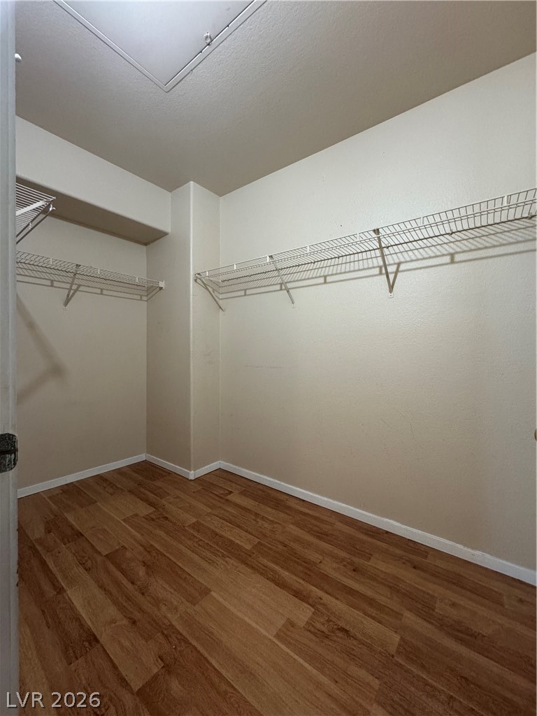 7255 West Sunset Road, Unit 2081 Las Vegas, NV 89113 - Photo 9 of 20 Walk in closet featuring dark wood-style flooring