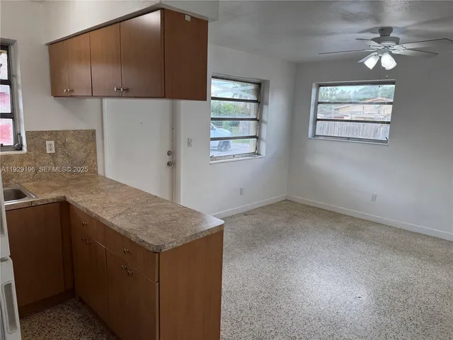 a kitchen with a sink cabinets and window