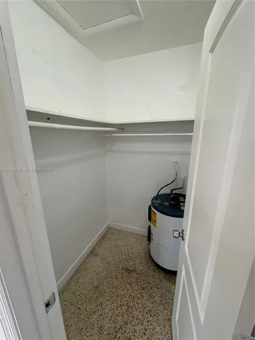 a room with a refrigerator and a sink