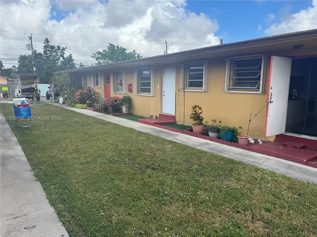 a front view of house with yard and outdoor seating
