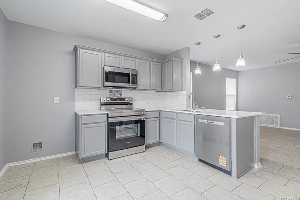 a kitchen with cabinets and window