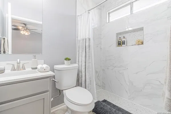 a bathroom with a toilet a sink and a shower