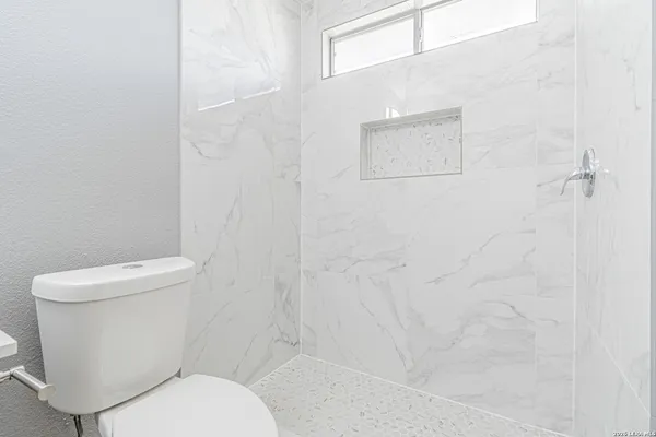 a white toilet sitting next to a white sink