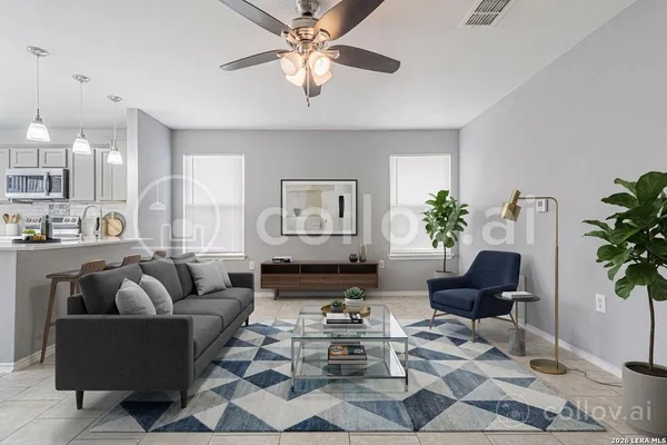 a living room with furniture potted plant and a window