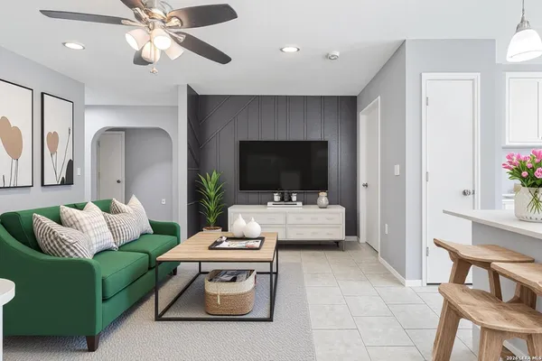 a living room with furniture and a flat screen tv