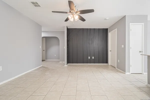 a view of an empty room with a ceiling fan