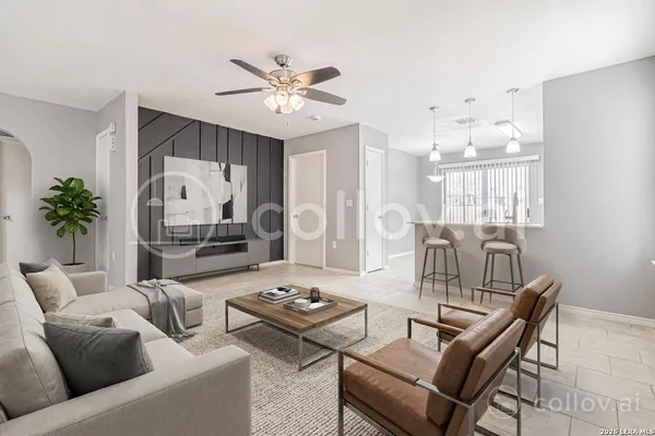 a living room with furniture and a chandelier