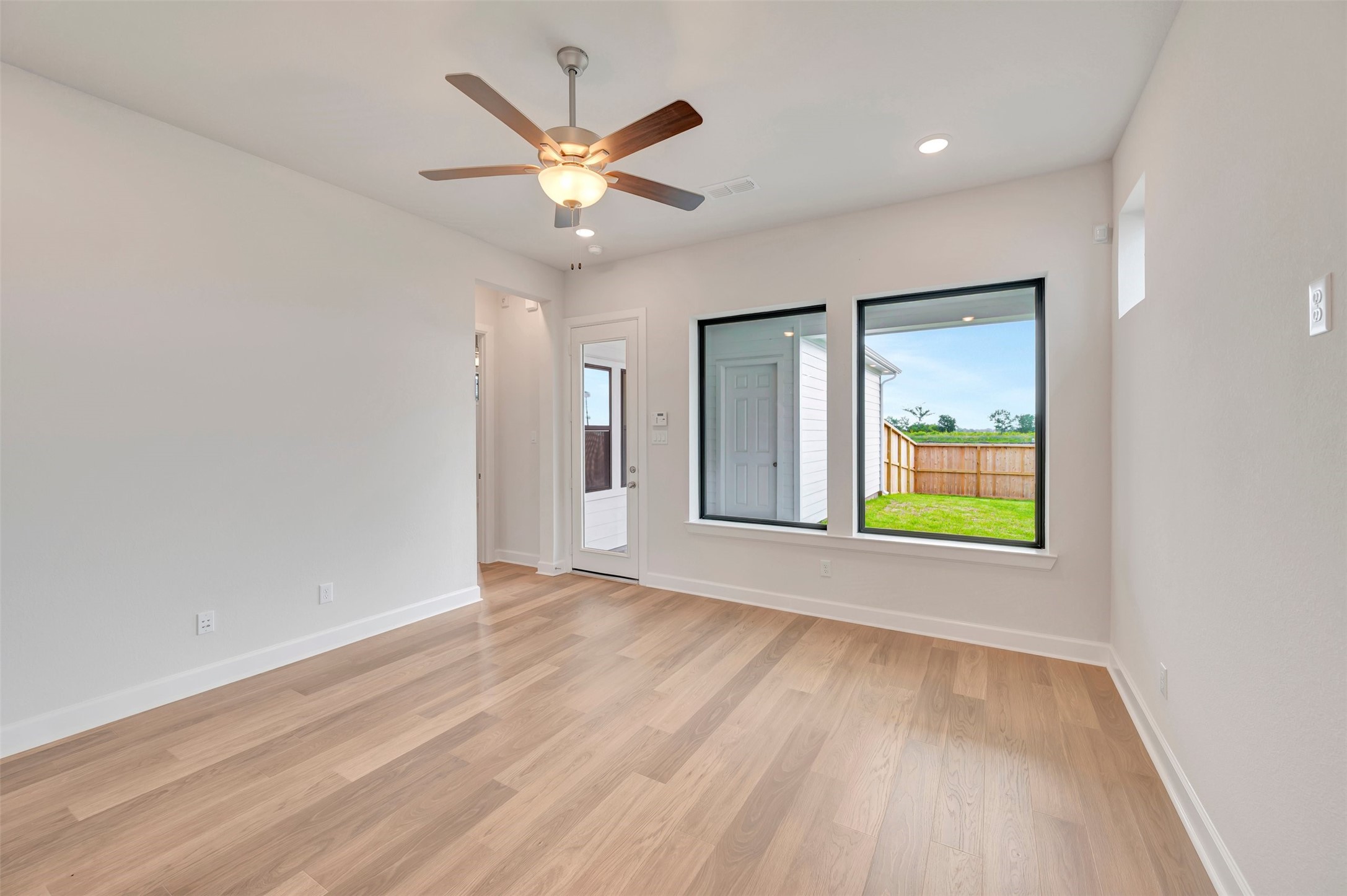 2718 Cottage Place Rosharon, TX 77583 - Photo 29 of 50 an empty room with window and wooden floor