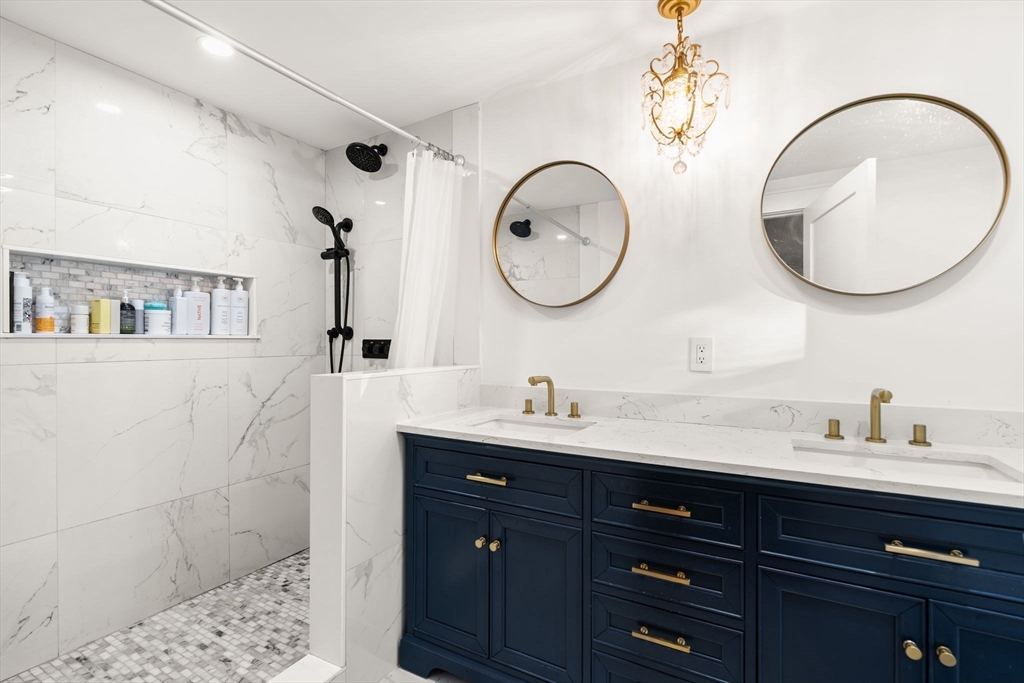 43 Oregon Road Ashland, MA 01721 - Photo 19 of 41 a bathroom with a double vanity sink and a mirror