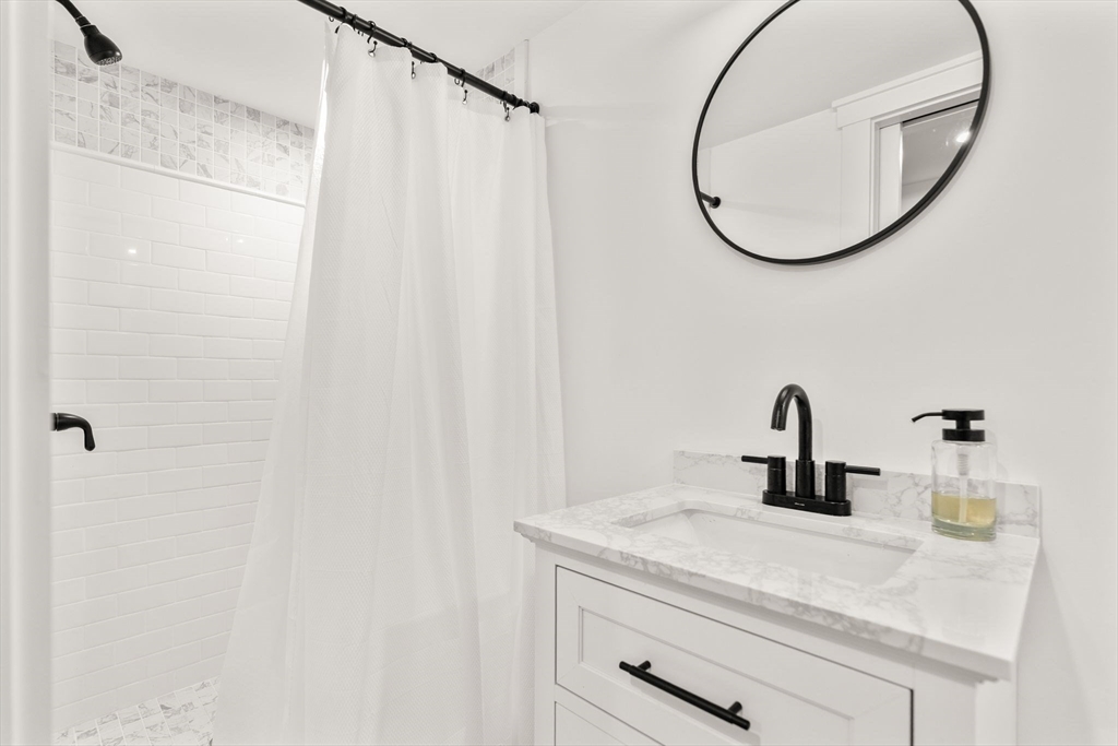 43 Oregon Road Ashland, MA 01721 - Photo 26 of 41 a bathroom with a sink and a mirror