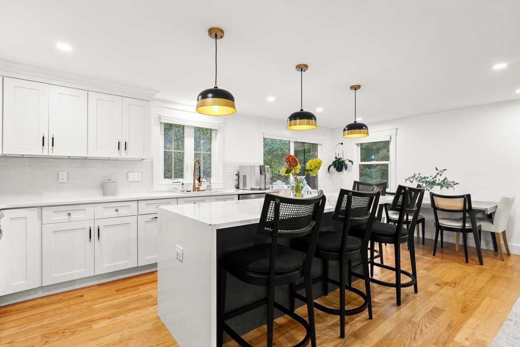 43 Oregon Road Ashland, MA 01721 - Photo 9 of 41 a kitchen with stainless steel appliances granite countertop white cabinets and chairs