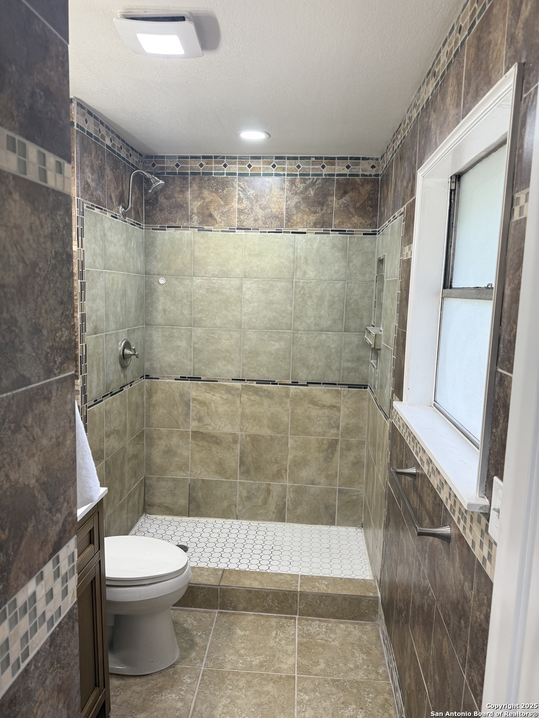 6831 Spring Rose Drive San Antonio, TX 78249 - Photo 13 of 18 a bathroom with a shower and a toilet