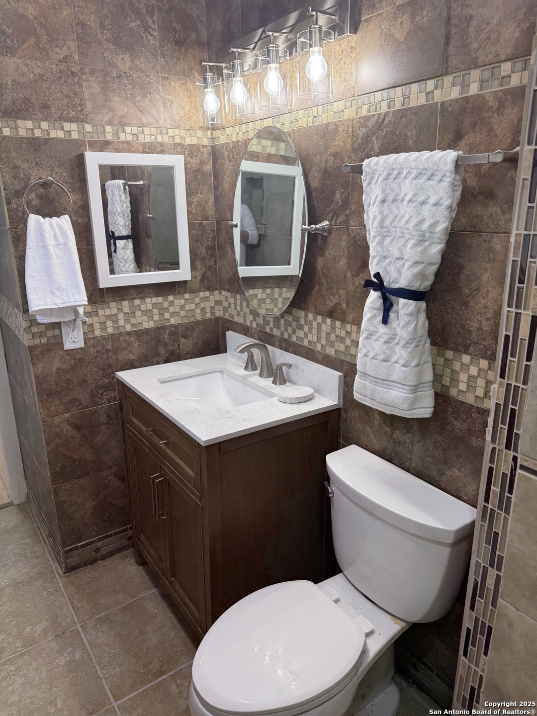 6831 Spring Rose Drive San Antonio, TX 78249 - Photo 14 of 18 a bathroom with a toilet sink and mirror
