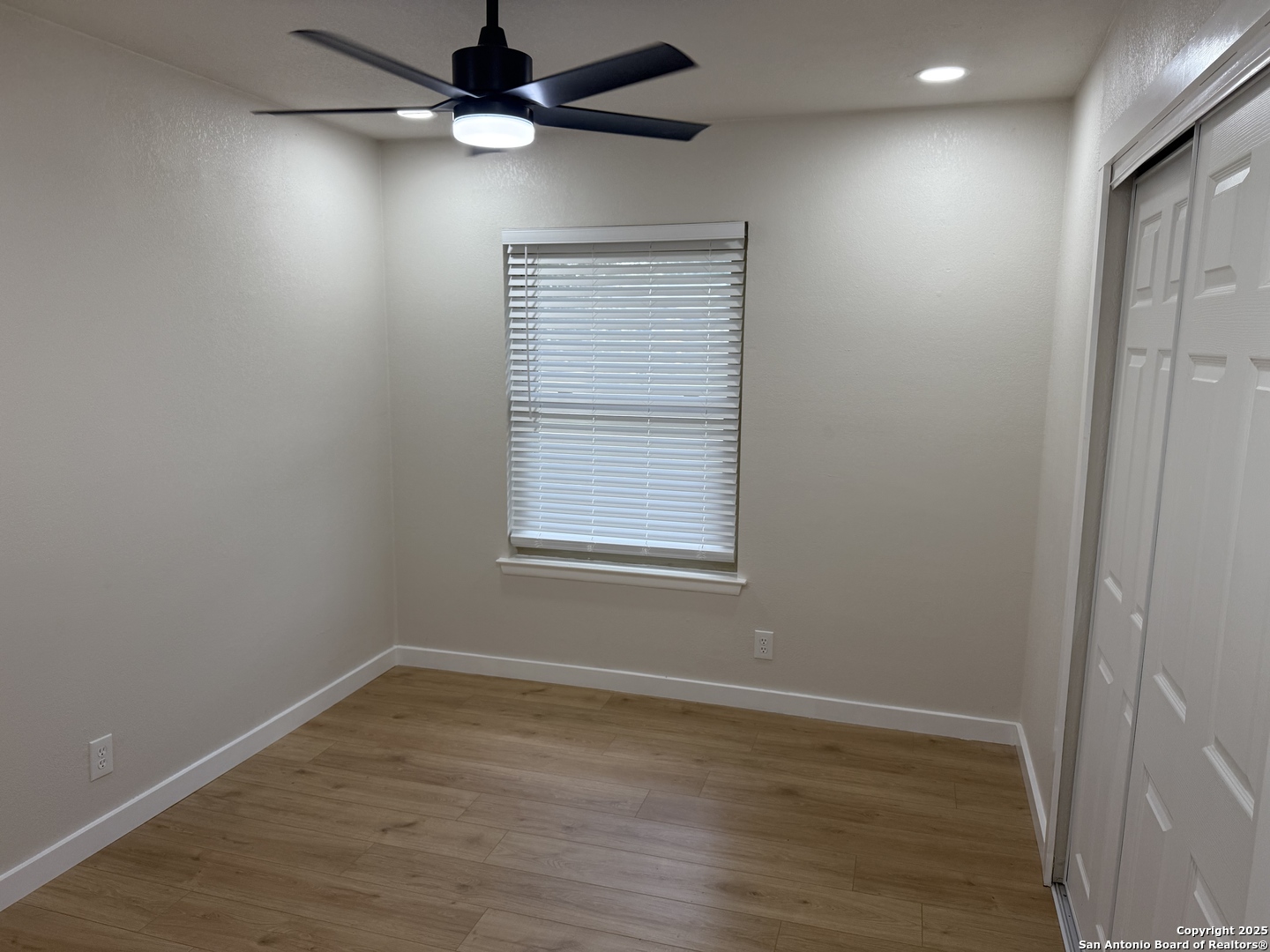 6831 Spring Rose Drive San Antonio, TX 78249 - Photo 9 of 18 wooden floor in an empty room with a window
