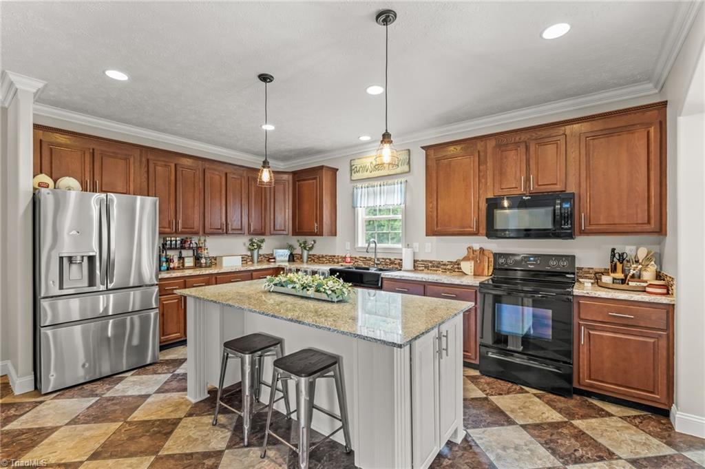 5092 Oneal Farm Road Trinity, NC 27370 - Photo 11 of 50 Spacious kitchen featuring abundant cabinetry and beautiful granite countertops