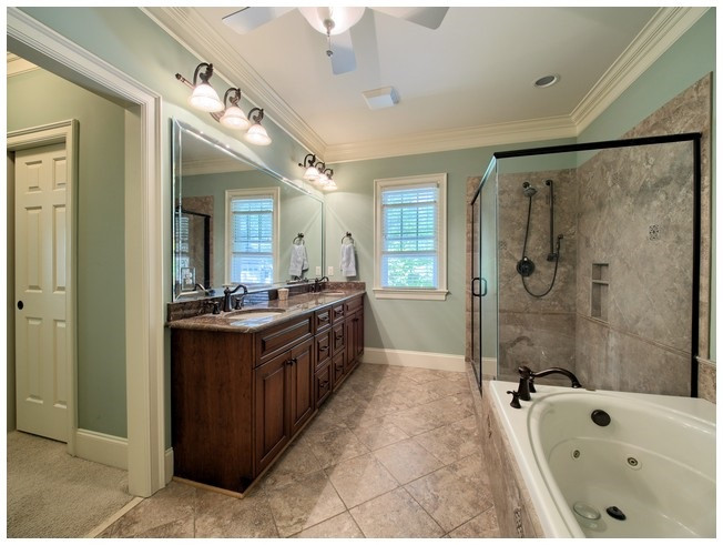 9709 Bailey Grove Court Raleigh, NC 27613 - Photo 14 of 25 The large master bath features an oversized walk-in shower, whirlpool tub, dual comfort height vanity with u/m sinks and separate water closet. Master Bath/Spa