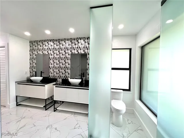 a living room with furniture and a toilet