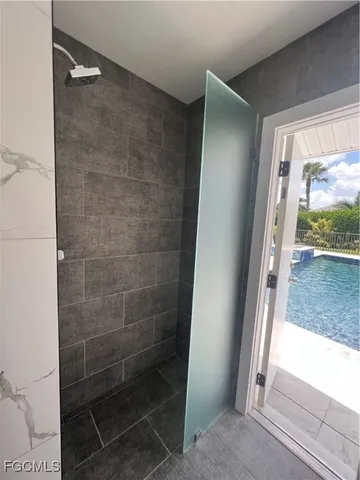 a bathroom with a glass shower door