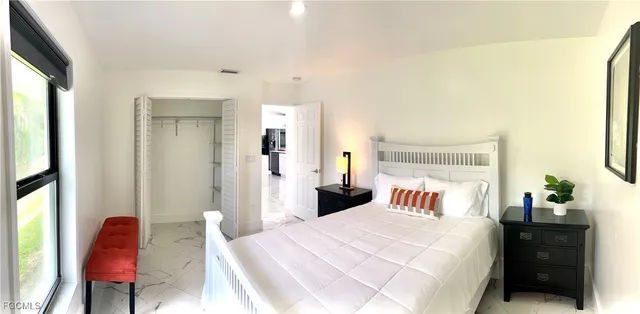 a bedroom with a bed and a chair