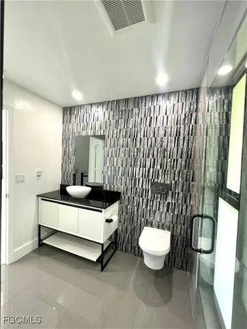 a bathroom with a toilet sink and a mirror