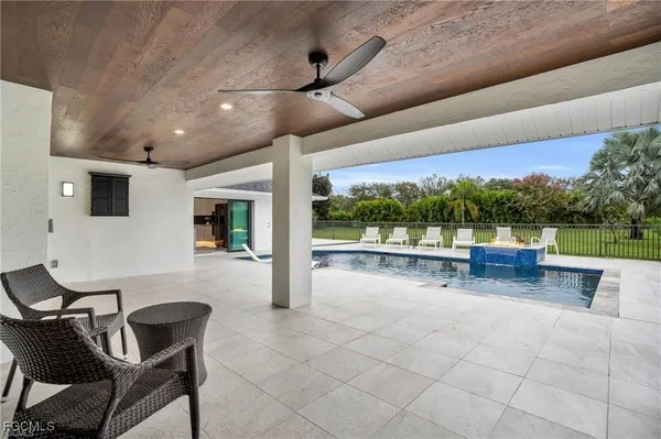 a view of a patio with a table and chairs