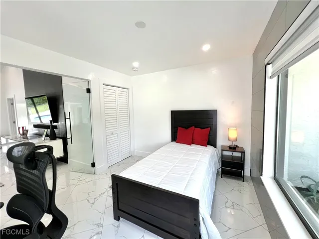 a bedroom with a bed and a couch