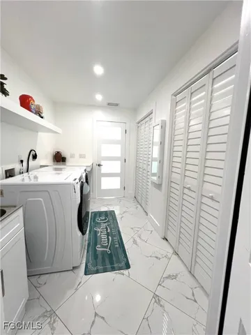 a room with stainless steel appliances a rug stove and a window