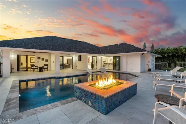 swimming pool view with a seating space