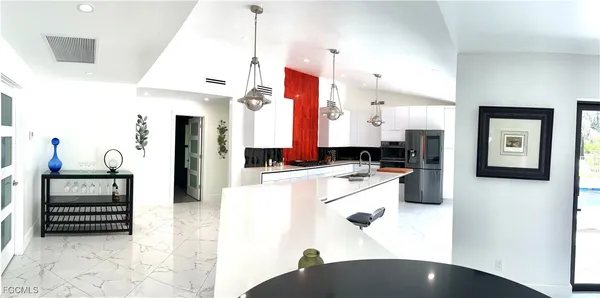 a kitchen with a refrigerator and a stove top oven
