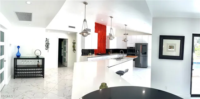 a kitchen with a refrigerator and a stove top oven
