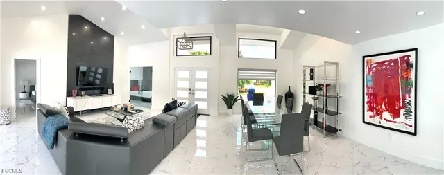 a living room with furniture and large window