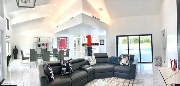 a living room with furniture and a floor to ceiling window