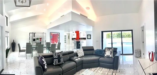 a living room with furniture and a floor to ceiling window