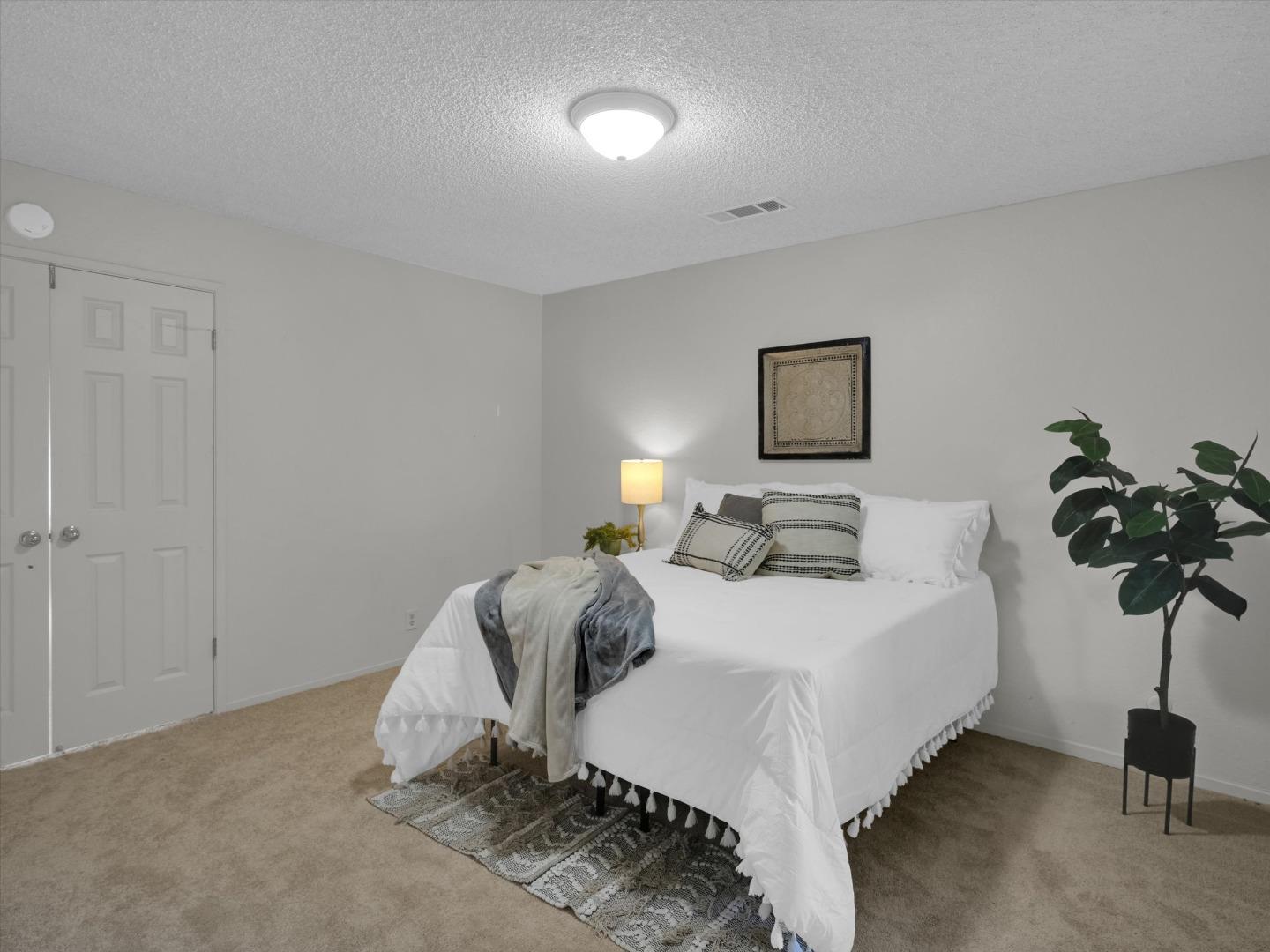 3559 Vernal Avenue Merced, CA 95340 - Photo 17 of 25 a bedroom with a bed and a lamp