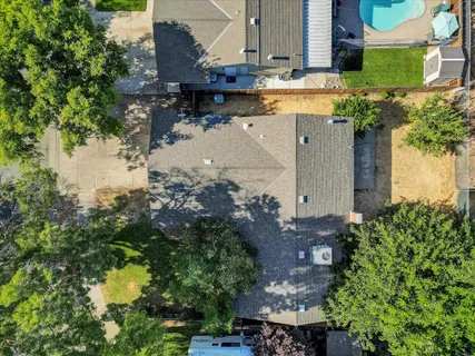 a view of a backyard with plants and a patio