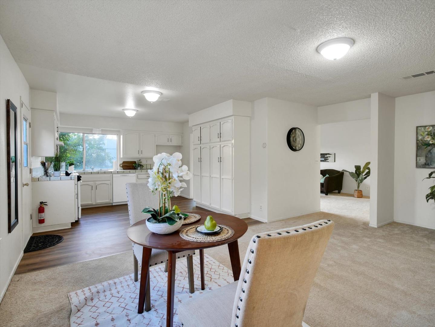 3559 Vernal Avenue Merced, CA 95340 - Photo 10 of 25 a living room with furniture and a dining table with potted plants