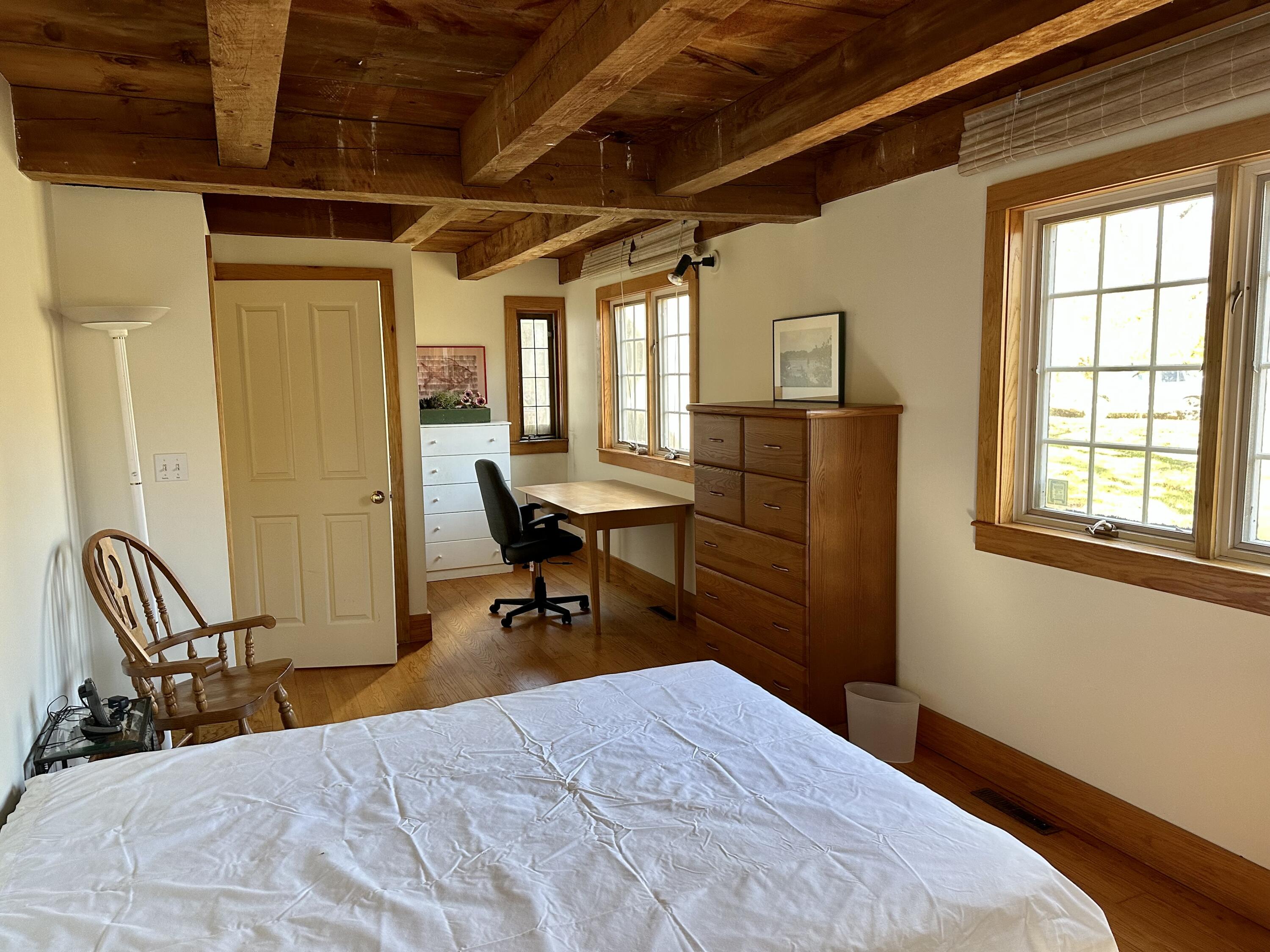 8 Harpoon Hollow Road Aquinnah, MA 02535 - Photo 15 of 29 a bedroom with a bed and wooden floor