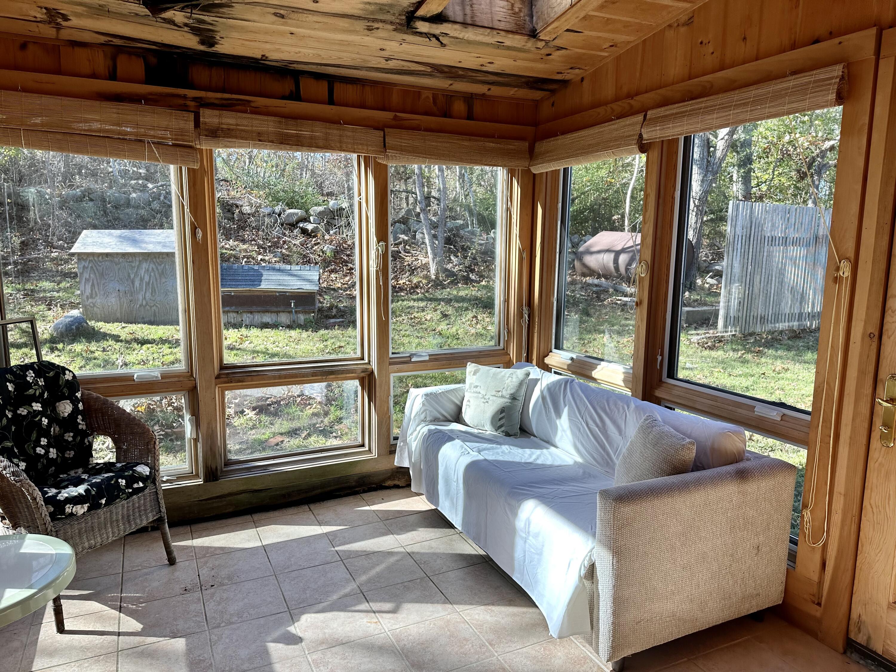 8 Harpoon Hollow Road Aquinnah, MA 02535 - Photo 17 of 29 a living room with furniture and a floor to ceiling window