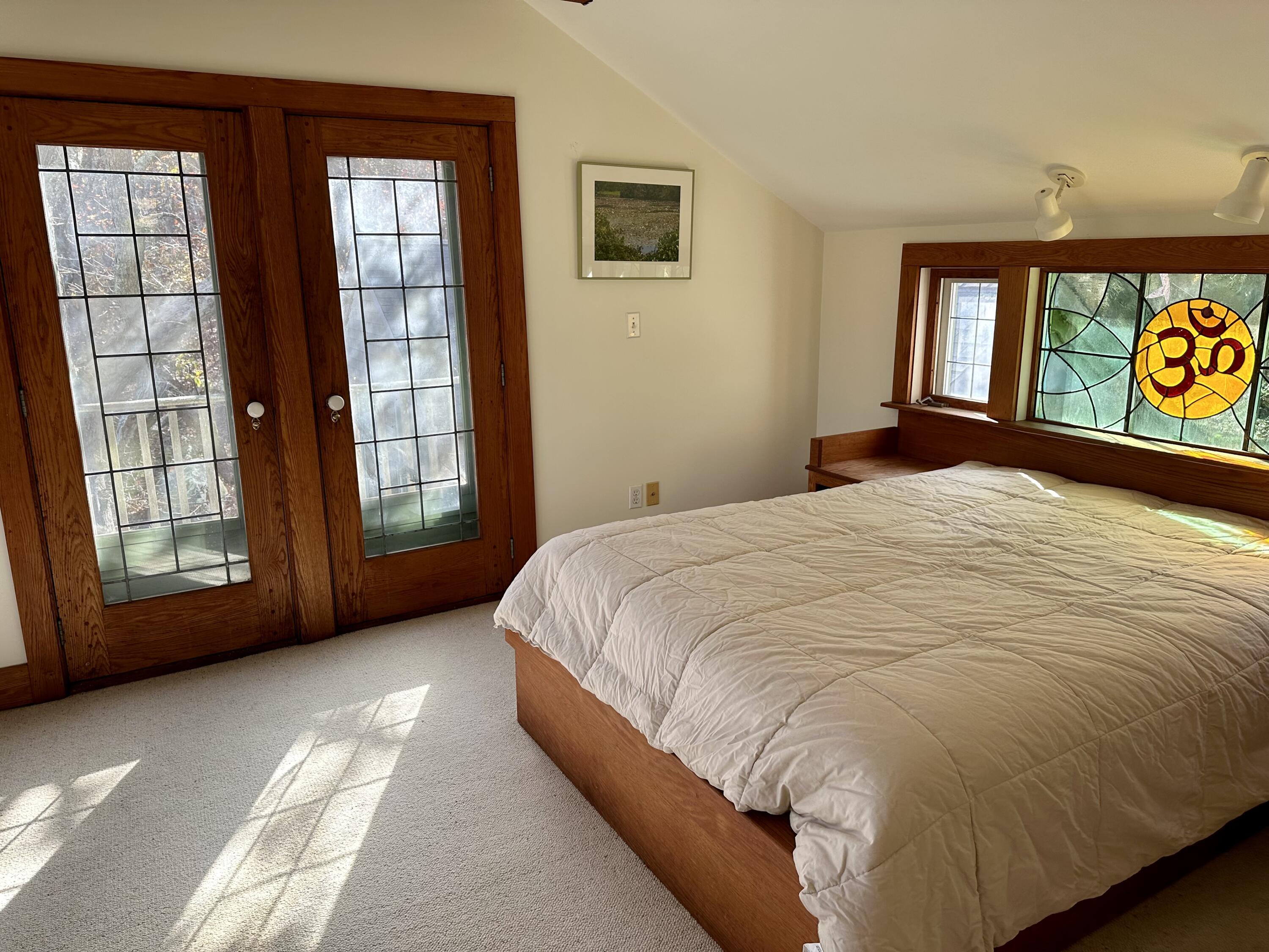 8 Harpoon Hollow Road Aquinnah, MA 02535 - Photo 18 of 29 a bed sitting in a spacious bedroom next to a window