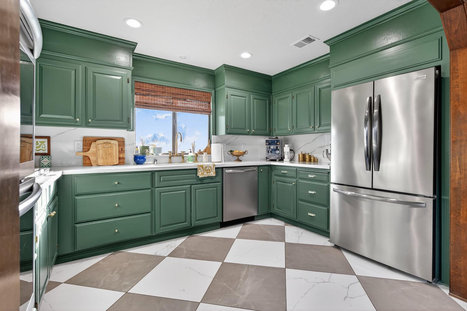 2348 Eilers Lane Lodi, CA 95242 - Photo 18 of 46 a kitchen with a refrigerator sink and cabinets