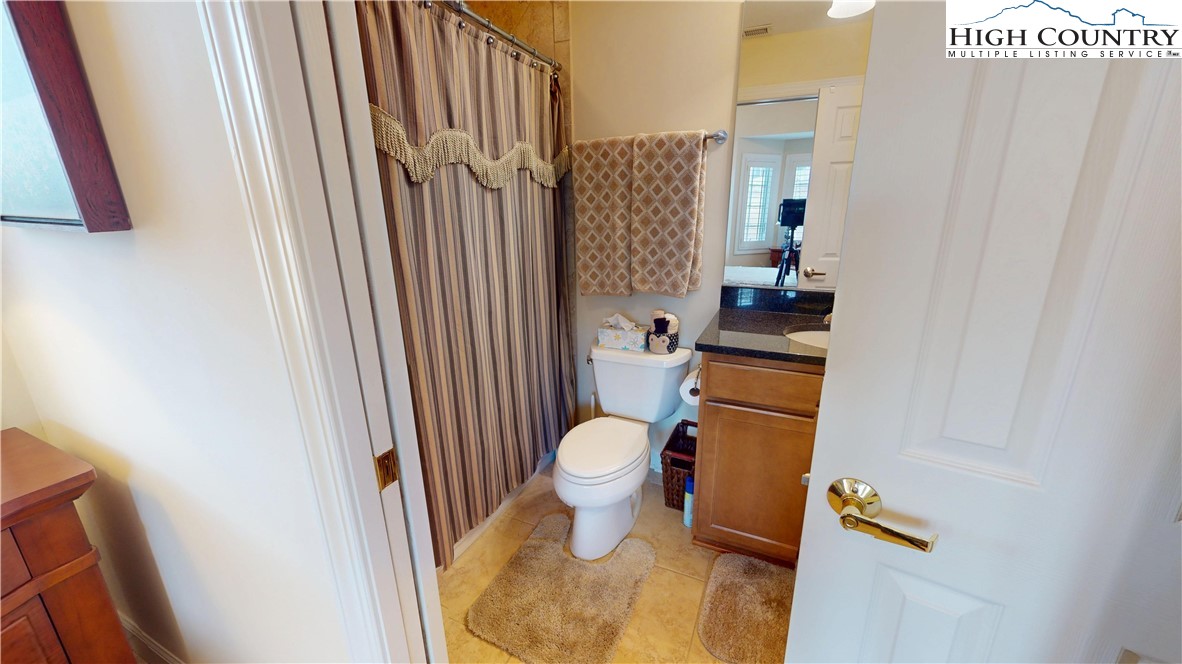200 Trails End, Unit 36A Sugar Mountain, NC 28604 - Photo 26 of 35 a bathroom with a toilet and a shower curtain