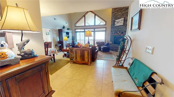 a living room with furniture a window and a flat screen tv