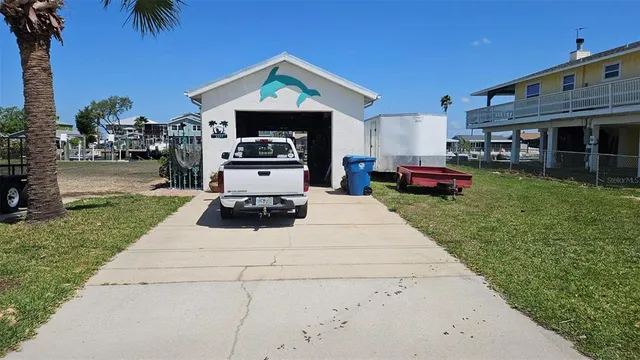 a view of a yard with table and chairs a barbeque