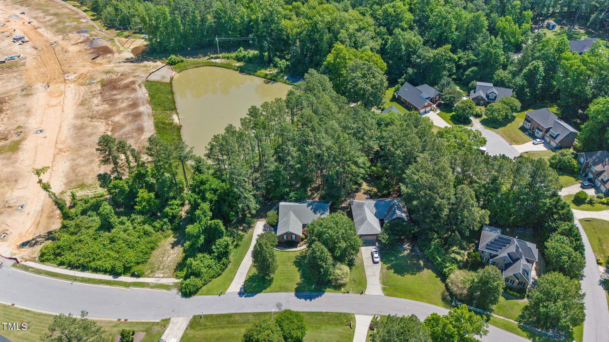 an aerial view of a house with a garden and swimming pool